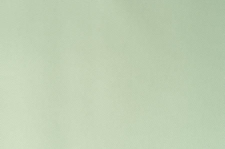 Soft green fabric serves as textured backdrop, perfect for creating peaceful interior aesthetic in various settings.の写真素材