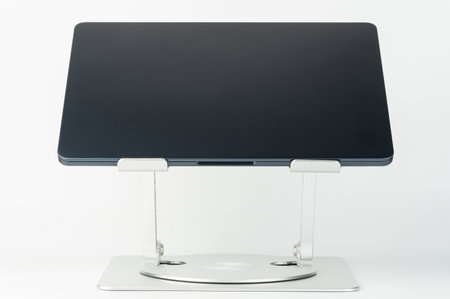 Sleek laptop stand enhances comfort and productivity for working or studying at home with its adjustable height and angle.の写真素材