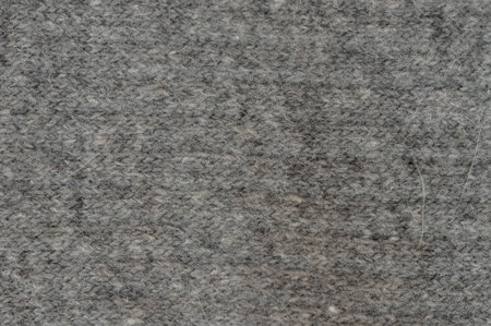 Soft gray textured fabric displays warm and inviting surface, perfect for various indoor design...