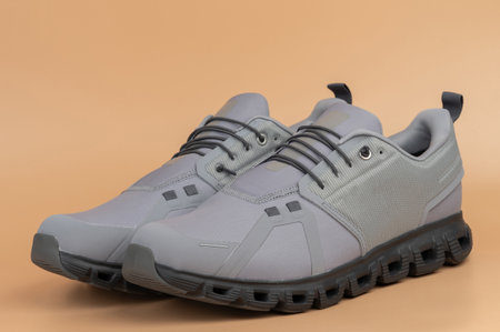 Lightweight gray athletic shoes ideal for running or training, showcasing modern design and comfortable fit for all-day wear.の写真素材