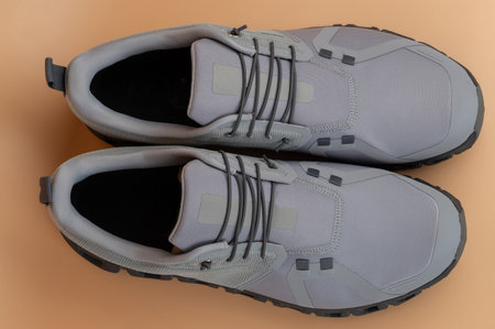 Modern gray athletic shoes feature lightweight design and offer support for various fitness activities and daily wear.の写真素材