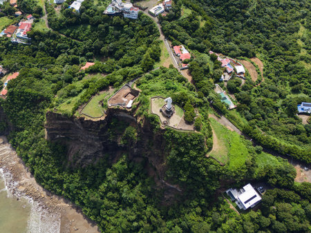 Green cliff with jesus christ statue above top drone viewの写真素材