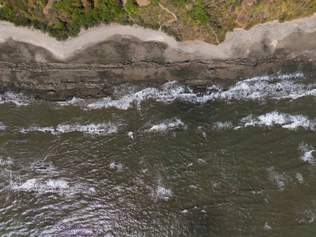 Rocky ocean beach background above top drone viewの写真素材