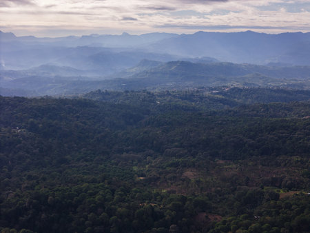 Misty mountains and valleys create serene landscape at dawn, showcasing beauty of nature and tranquility.の写真素材