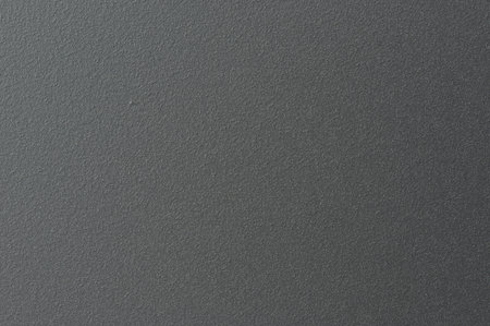 Surface shows a dark, textured look with clear details. Light interacts with its surface, creating depth and shadows.の写真素材