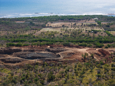 Sand quarry next to beach coastline aerial drone view