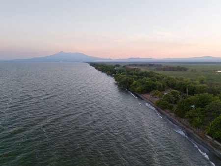 Lake shore with green trees and volcano background aerial drone viewの写真素材