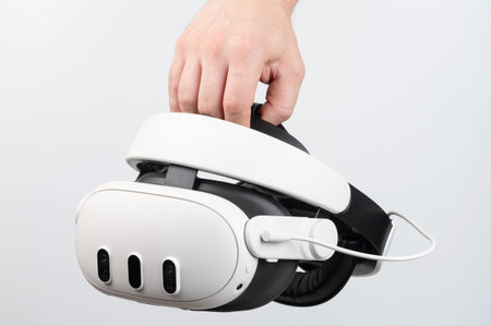 Virtual reality headset in hand close up view isolated on studio backgroundの写真素材