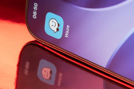 New York, USA - February 23, 2026: Waze icon application on smartphone screen close up with pink...
