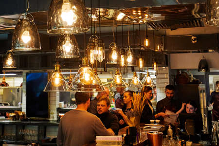 Moscow, Russia, 06.05.2018: A group of men sitting at a table, talking and drinking alcoholのeditorial素材