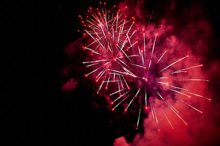beautiful holiday red fireworks in the skyの写真素材