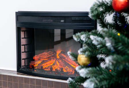 Living room home interior with decorated fireplace and christmas treeの写真素材