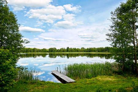 dock on the banks of the River, sky reflection in waterの写真素材