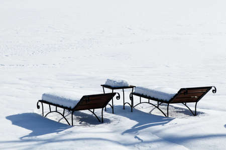 sun beds in the snow, sunbathing in the winterの写真素材