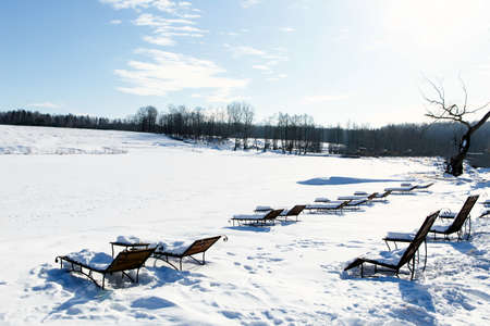 deck chairs on a winter beach in the winter under the snow, go for a winteringの写真素材