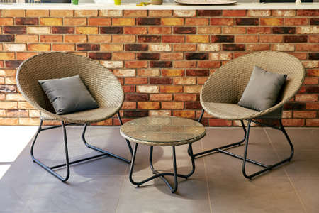table and chairs against a backdrop of brick wallの写真素材