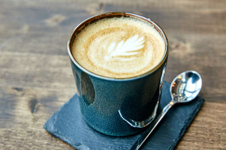 a cup of coffee on a wooden tableの写真素材