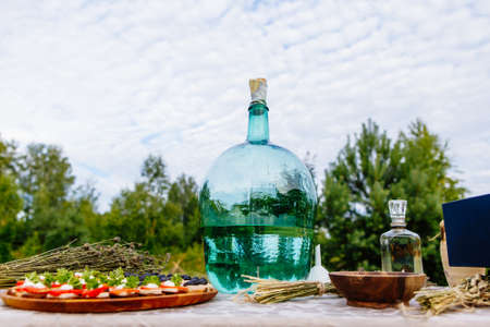 bottle of moonshine, hooch, hootch on the tableの写真素材