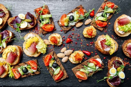 many different types of snacks on the tableの写真素材