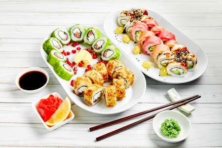Closeup of traditional japanese sushi set with salmon and tuna fish isolated on white background. Sushi bar menu design with copyspace.の写真素材