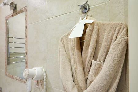white Bathrobe on a hanger at bathroomの写真素材