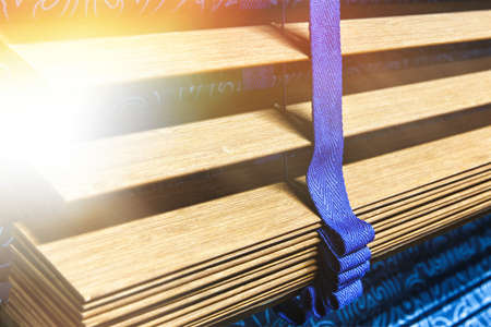 Wooden shutters blinds (Windows blinds) with the light sunshineの写真素材