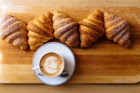 different types of croissants with coffee on tableの写真素材