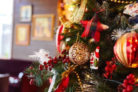 Christmas tree decorated with red bows, stars balls, New Year decorations の写真素材