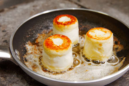 three lush toasted cheesecakes, fried in a pan, in butter, cooking, flour productsの写真素材