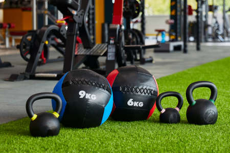 kettlebells of different sizes and different weights are in a row, close-up, gym, sports equipmentの写真素材