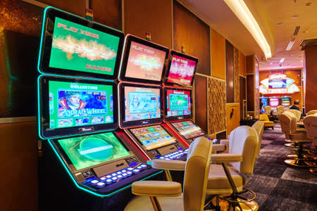 Moscow, Russia, 15.08.2019, casino, large hall with slot machines with armchairs, fortune games, prize winningのeditorial素材
