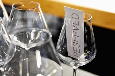large glass goblets with pieces of paper reserved inside, on a blurred background