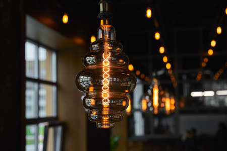 Edison light bulb in the interior of a cafeの写真素材