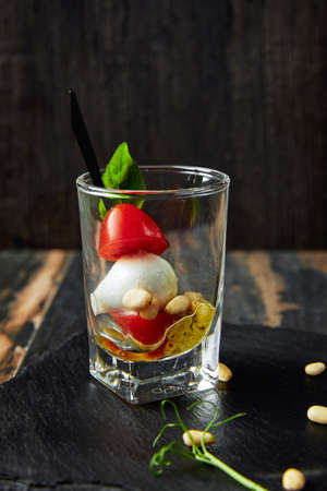 Caprese salad - skewer with tomato, mozzarella and basil, italian food and healthy vegetarian diet conceptの写真素材