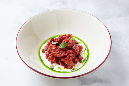 Beef tartar with cheese sauce on light background.の写真素材