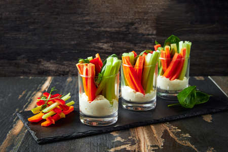 The sticks of carrots and celery with sauce, healthy snacks.の写真素材