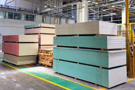 Gypsum plasterboard in pack. Pallet with plasterboard in the building store. Construction Materials. Drywall warehouseの写真素材