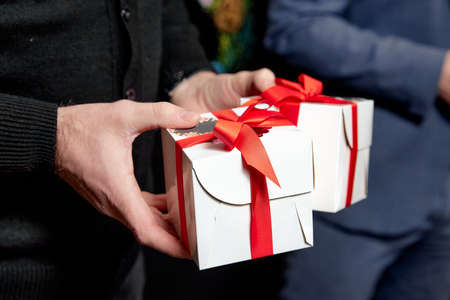 mans hands Holding Gift box In Packageの写真素材