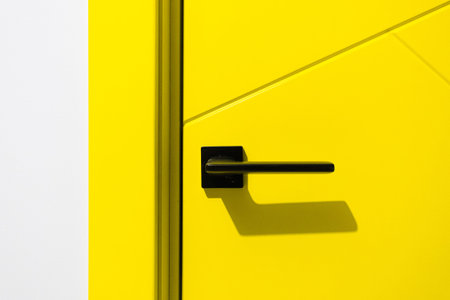 yellow door with black handle close up
