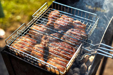 Barbecue chicken on the grill is fried on the grill with smokeの写真素材
