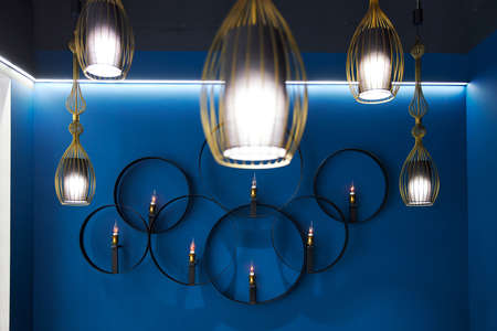 many hanging lamps on the ceiling and on the blue wallの写真素材