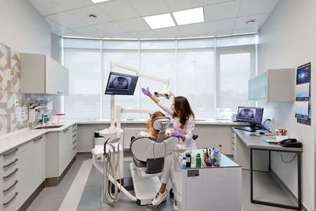 Moscow, Russia, 10.04.2021, stomatology room with all equipment, seat, doctor and patientのeditorial素材