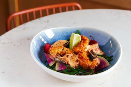 deep-fried shrimp with exotic fruits in a bowl on the table, saladの写真素材