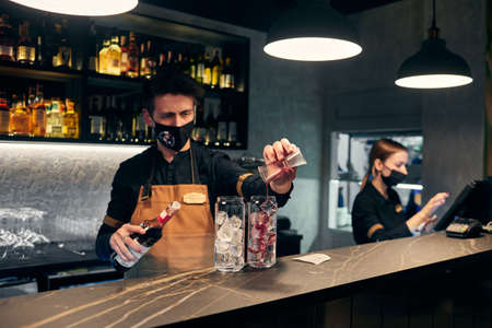 Moscow, Russia, 12.01.21, the bartender prepares a cocktail with ice behind the barのeditorial素材