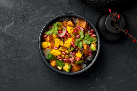 poke with caviar, fish, pomegranate and radish, decorated with parsleyの写真素材