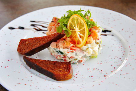 Olivier with slices of bread decorated with lemon with sauce