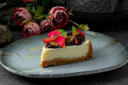 Tasty cheesecake with syrup and blueberries on plateの写真素材