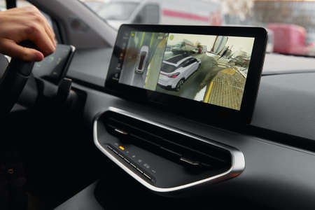Person drives car with navigation system along city streetの写真素材
