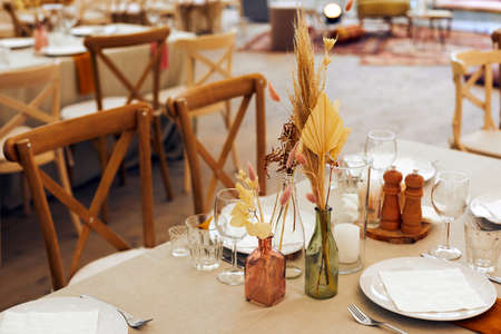 Table setting with dry flower bouquets in restaurantの写真素材