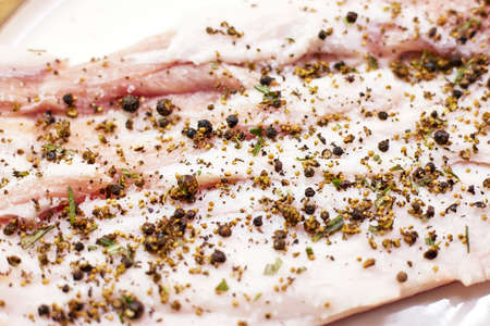 Delicious pork lard with pepper and spices as backgroundの写真素材